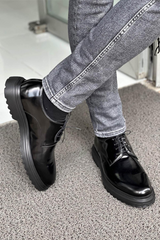 Elegant black leather formal derby shoes featuring a sleek design, sturdy lace-up closure, and durable rugged sole,