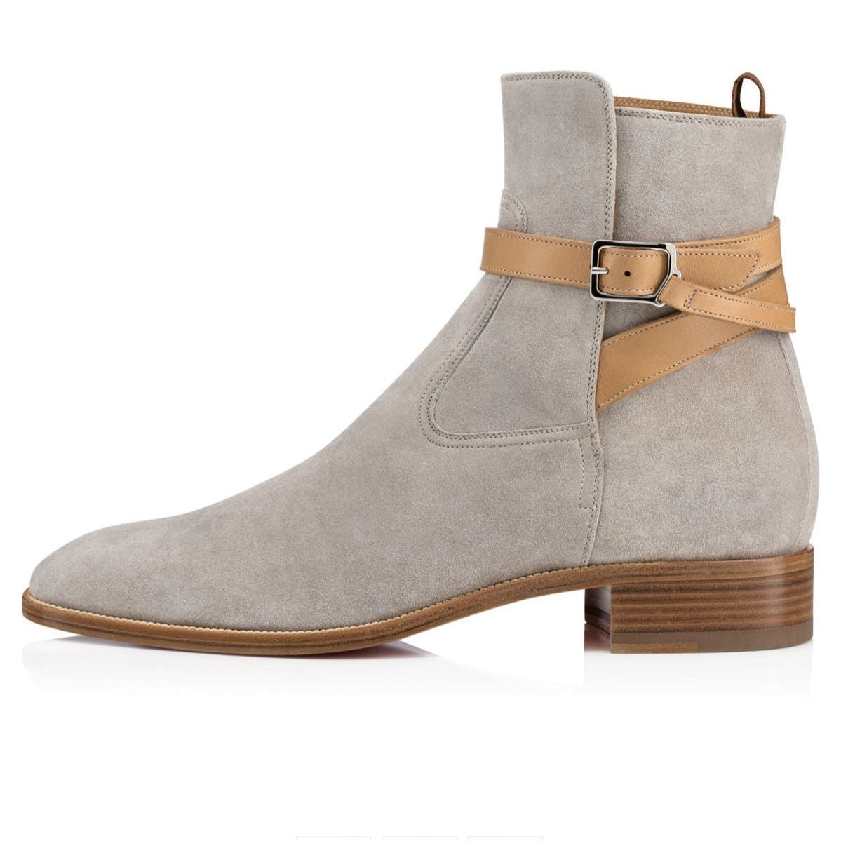 Gray suede boot with brown strap and sole on a white background
