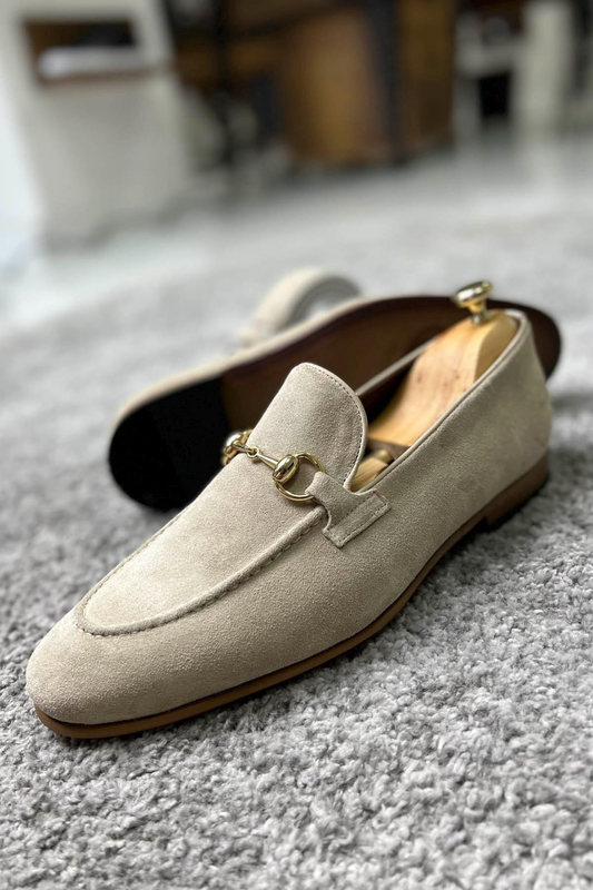 Stylish beige suede loafers with gold bit accents, perfect for classy and sophisticated occasions.